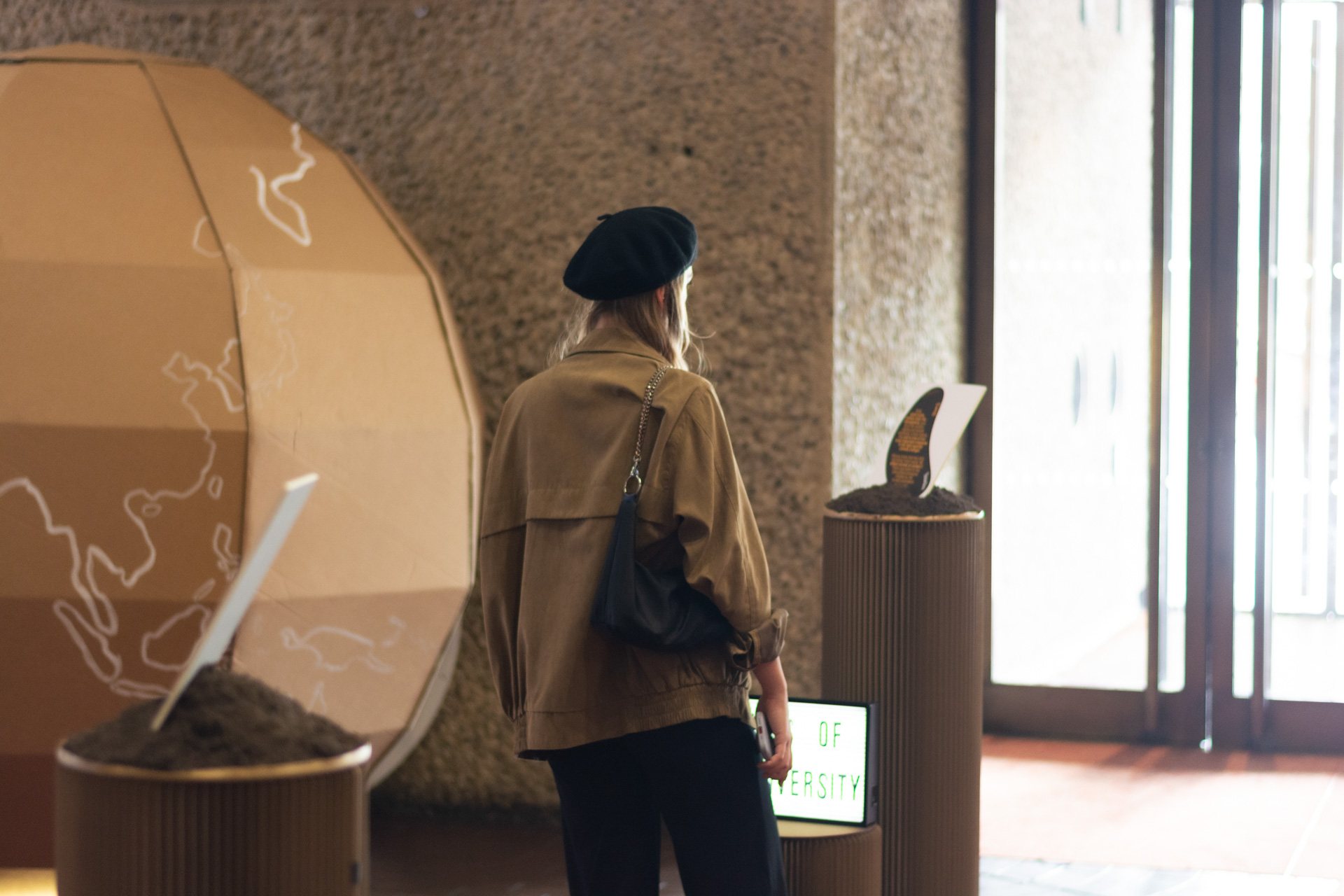 A visitor beside the cardboard globe