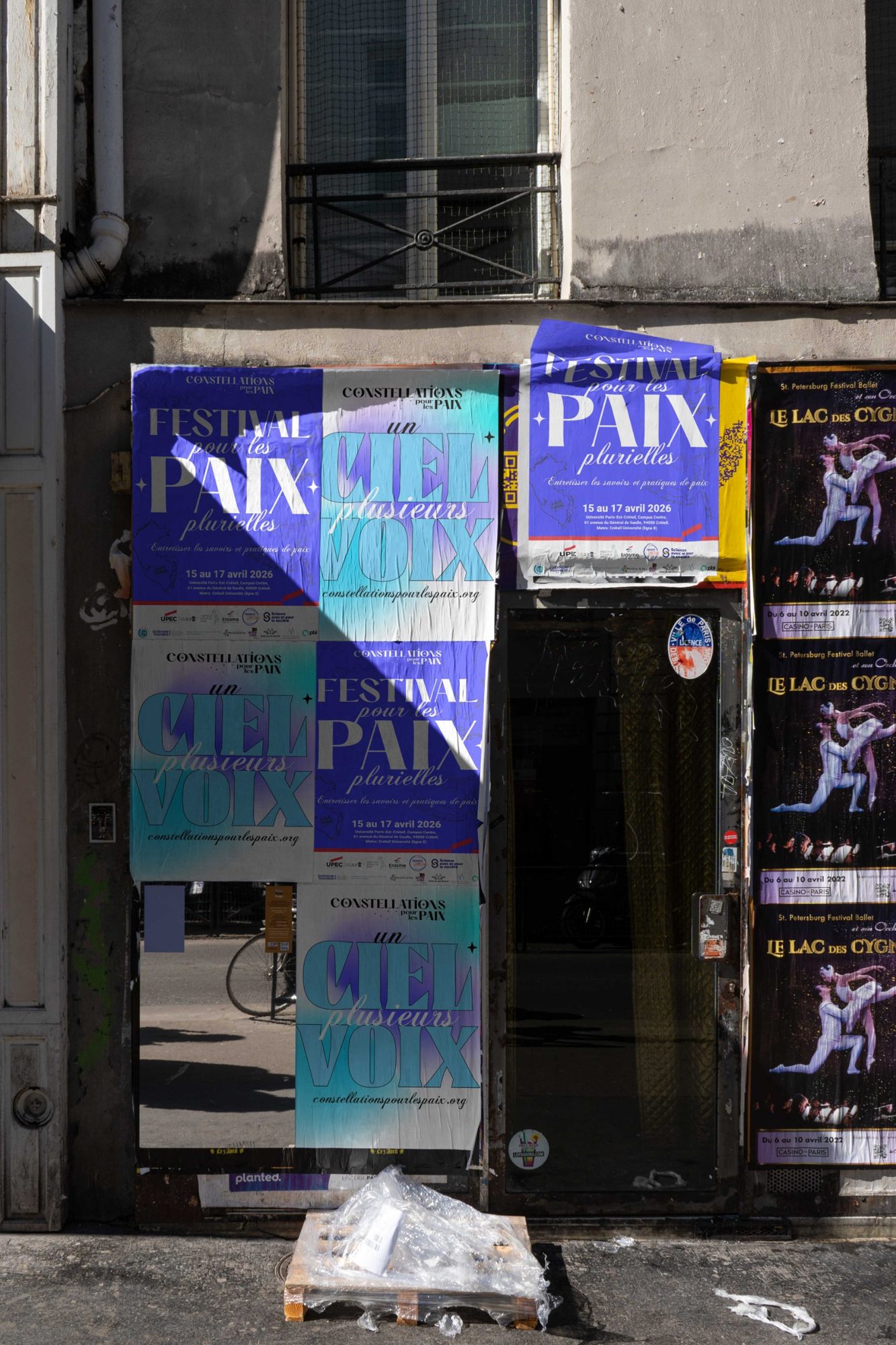 Festival and campaign posters pasted on a street wall
