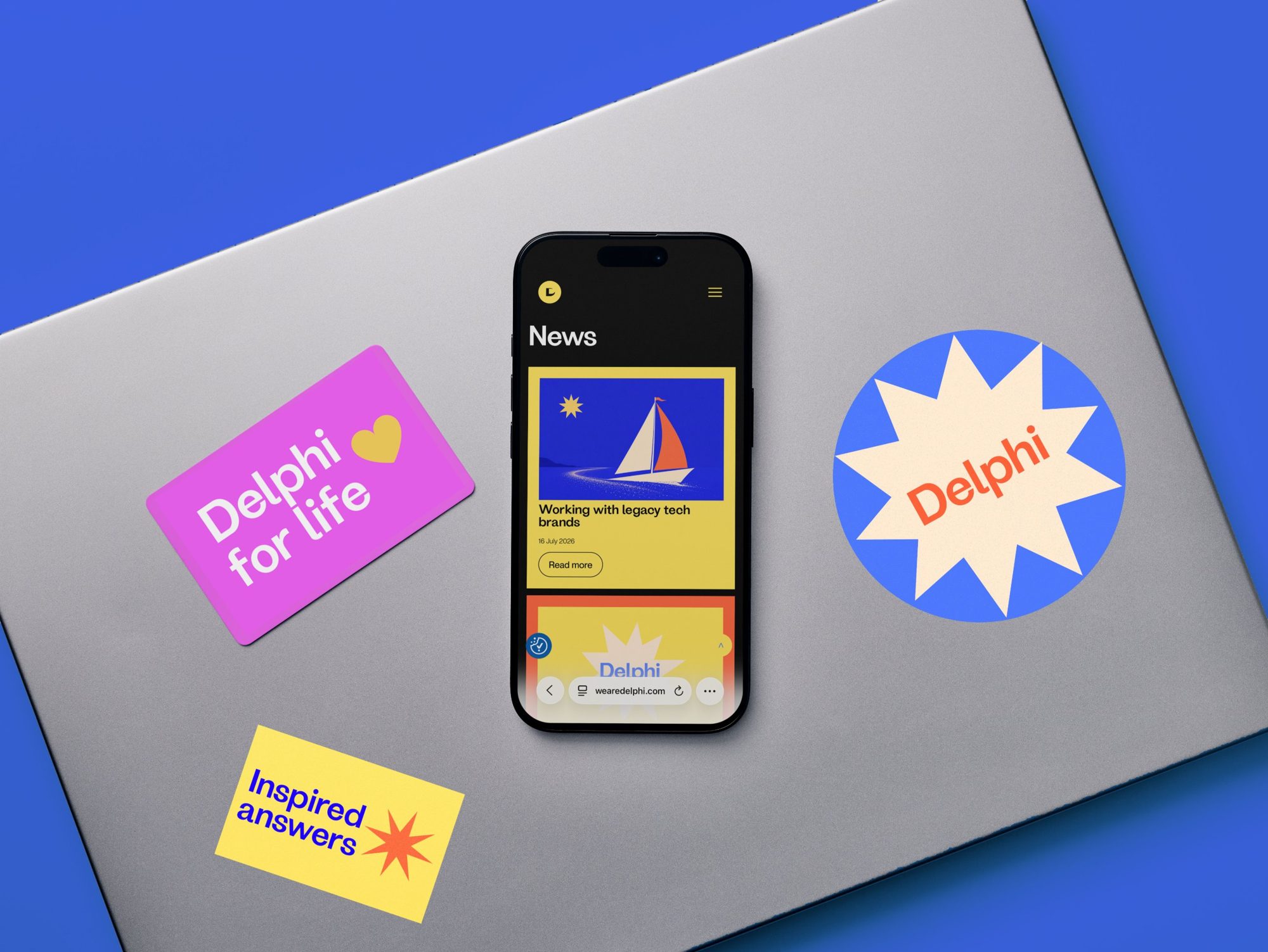 Laptop stickers and the Delphi website on a phone