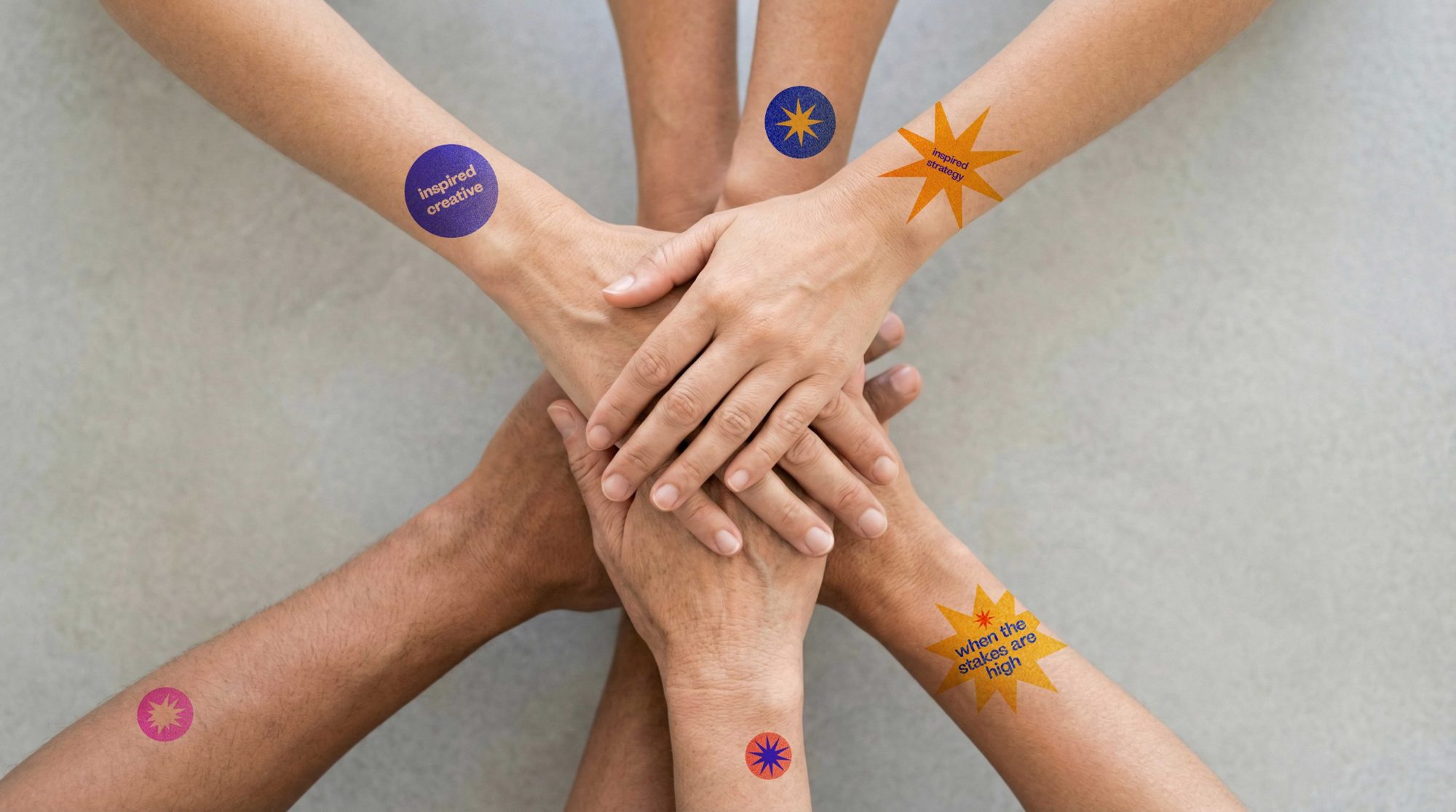 Temporary tattoos with Delphi lines on stacked hands
