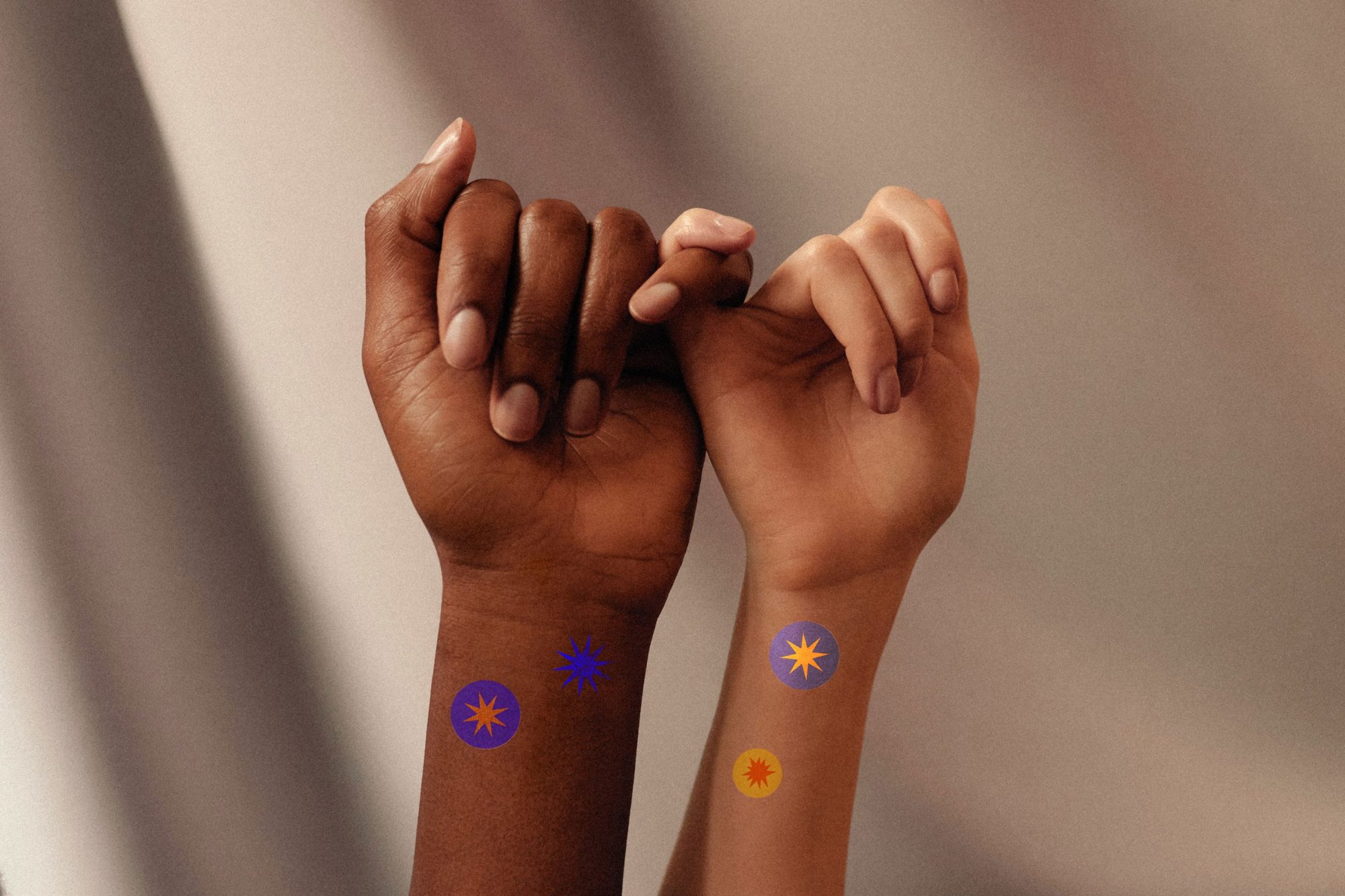 Star temporary tattoos on two wrists