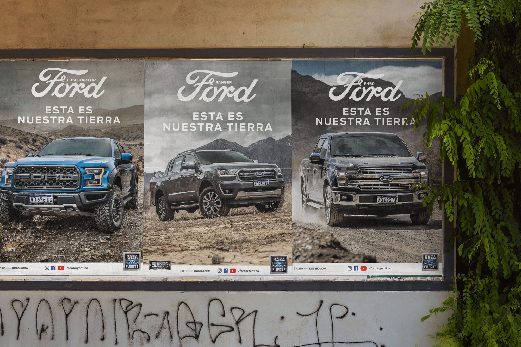 Three Esta es nuestra tierra posters on a street wall