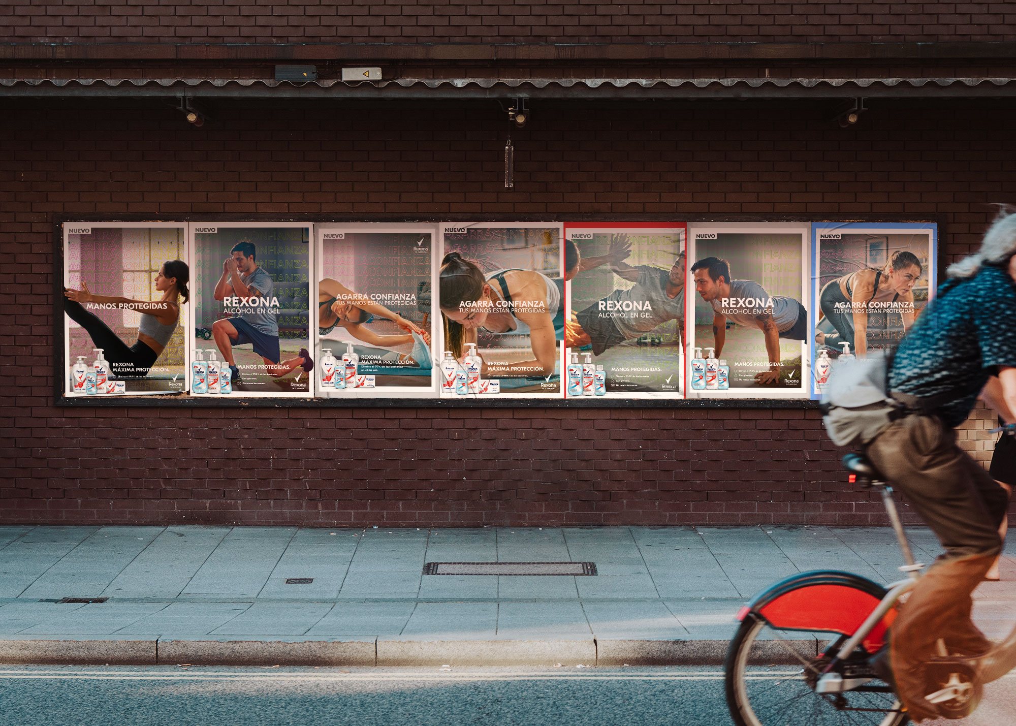 Row of Agarrá Confianza posters on a brick wall